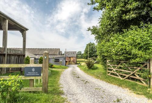 a gravel road with a fence and a barn at Loaf in Bridport