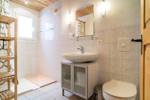 a bathroom with a sink and a toilet at Apartment Rybibach Retreat in Lauterbrunnen