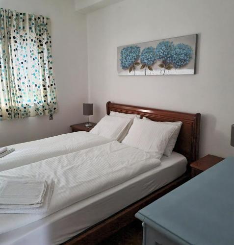 a bed with white sheets and pillows in a bedroom at Quinta da Gandarela in Tarouca
