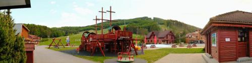 a park with a playground with a play equipment at Apartmány Valča in Valča