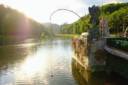 a body of water with a fishing pole in the water at Apartmány Valča in Valča
