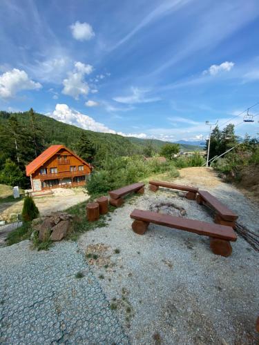 a group of benches in front of a cabin at Apartmány Valča in Valča