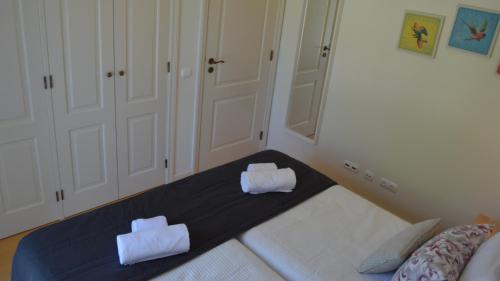 a bedroom with a bed with two towels on it at Quinta Formosa Villa in Quinta do Lago