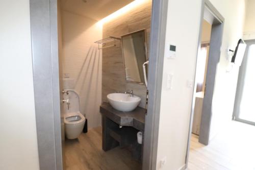 a bathroom with a sink and a toilet at The Palms novasithonia in Vourvourou