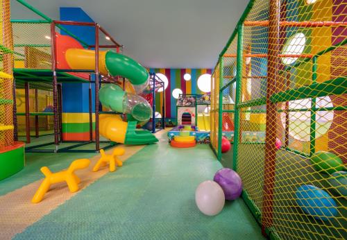 a play room with a playground with a slide at Elexus Hotel Resort & Spa & Casino in Kérynia