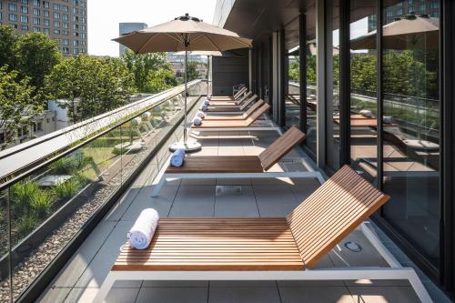 a row of benches on the balcony of a building at Meliá Frankfurt City in Frankfurt