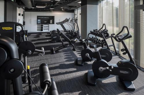 a gym with rows of exercise bikes and weights at Meliá Frankfurt City in Frankfurt/Main
