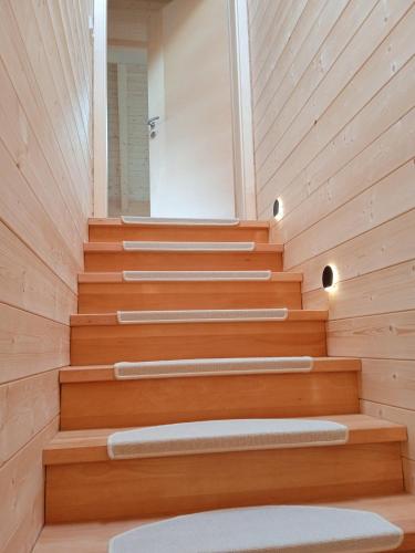 a room with wooden stairs with a mirror at Ferienwohnung Fernweh in Bolsterlang