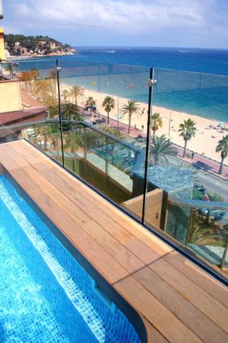 a swimming pool with a view of the beach at Hotel Miramar in Lloret de Mar