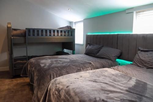a bedroom with two beds and a bunk bed at 19 Rodney Street Apartments in Liverpool