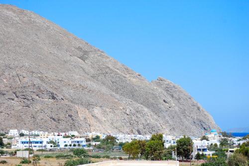 a mountain with a town in front of it at Apollo Rooms in Perissa