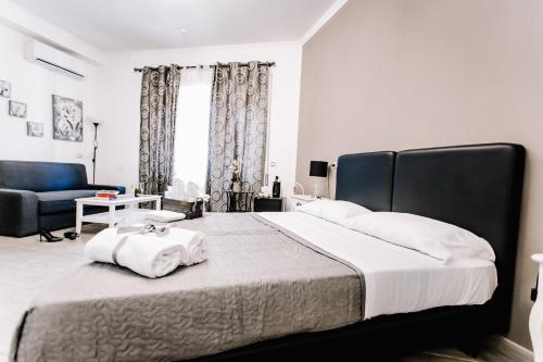 a bedroom with a large bed with towels on it at Wanderlust Relais Vaticano in Rome