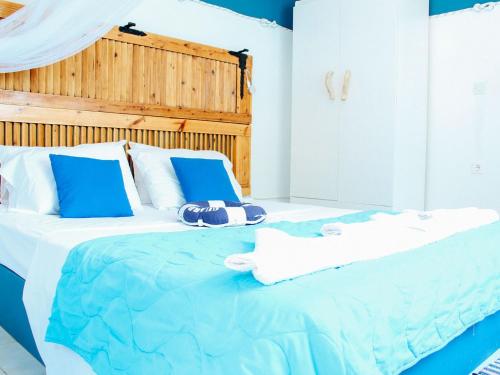 a blue and white bed with towels on it at Klima Paradise in Klíma