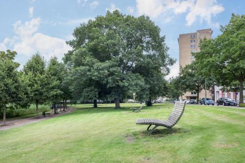 a park with two benches in the grass at Ferienwohnung Ausblick in Bremerhaven