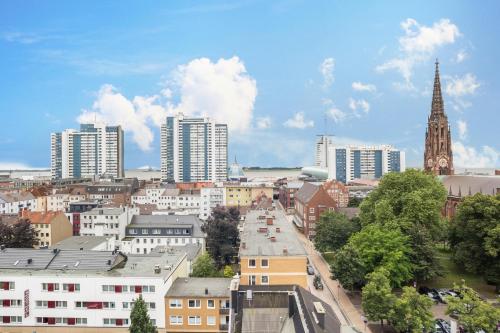 a view of a city with buildings and a clock tower at Ferienwohnung Ausblick in Bremerhaven