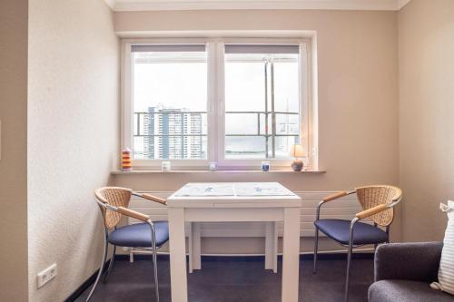 a room with a table and two chairs and a window at Ferienwohnung Ausblick in Bremerhaven