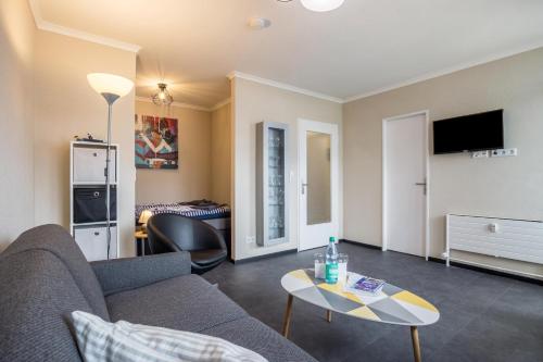 a living room with a couch and a table at Ferienwohnung Ausblick in Bremerhaven