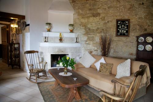 a living room with a couch and a fireplace at Walnut Grove in Vouni