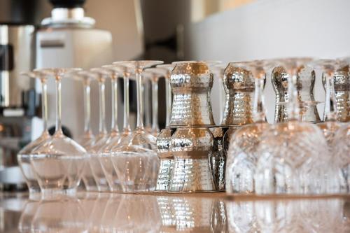 a group of wine glasses sitting on a counter at Golden Tulip Porto-Vecchio in Porto-Vecchio