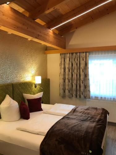 a large bed in a room with a window at Ritterhof in Fiss