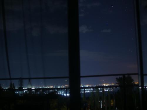 a view of a city at night from a window at Byurakan Guesthouse & Cottage in Byurakan