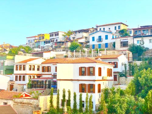 a white house on top of a hill with houses at Villa Ephesus Hotel in Kusadası