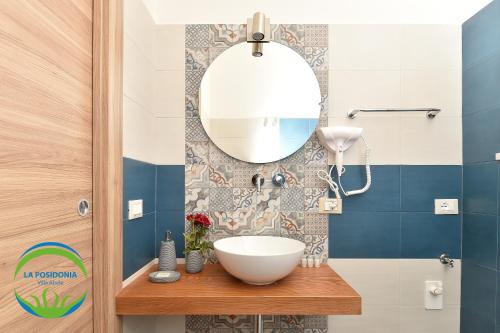 a bathroom with a sink and a mirror at La Posidonia - Villa Abele in Marsala