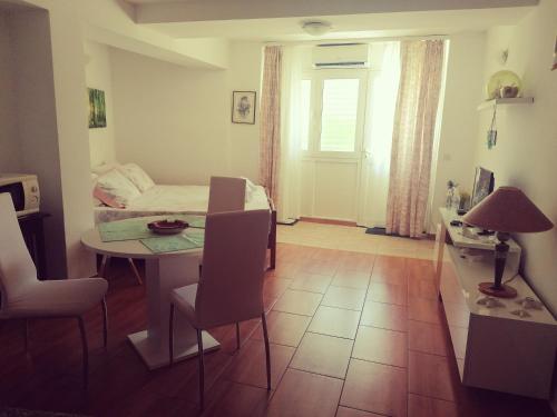 a living room with a table and a bed at Apartment Lju on the Beach in Split