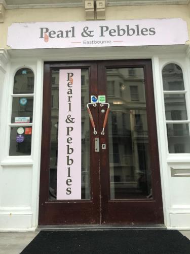 a front door of a store with a sign on it at Pearl & Pebbles Eastbourne in Eastbourne