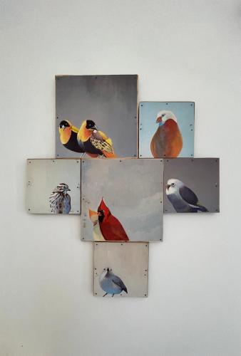 a group of four pictures of birds on a wall at Villa Huruma in Paje