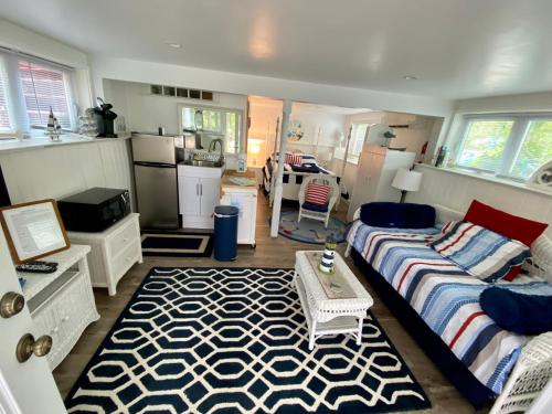 a living room with a bed and a kitchen at Clear Pond Suite in Plymouth