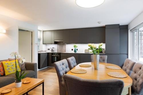 a kitchen and dining room with a table and chairs at Spacious 3 bedroom apt in Covent Garden in London