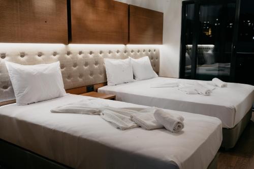 Dos camas en una habitación de hotel con toallas. en Ceneviz Suit Hotel en Akcakoca