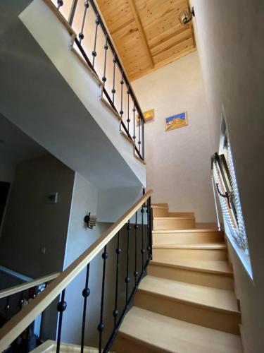 a staircase in a house with wooden ceilings at Vincent in Tbilisi City