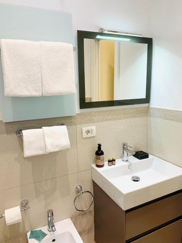a bathroom with a sink and a mirror at Via Del Corso Home Roma in Rome