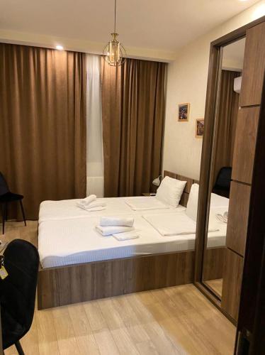 a bedroom with a large bed with a mirror at Vincent in Tbilisi City