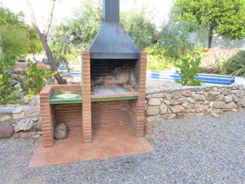 a brick oven sitting on top of a patio at Hort de la Cinteta in Alcover