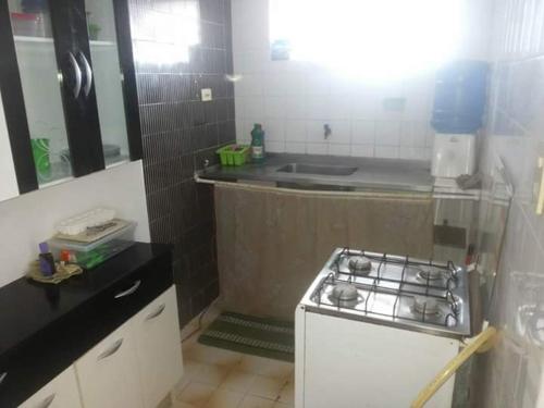 a kitchen with a sink and a stove in it at Temporada Carnaval Praia Olinda e Recife in Paulista