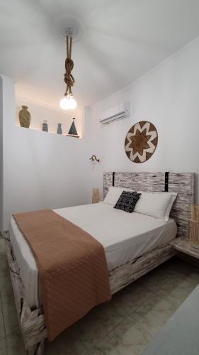 a bedroom with a large bed with a wooden headboard at Alexandra's Boutique House in Triovasálos