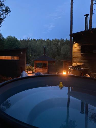 a swimming pool in a backyard with a gazebo at Villa Falco in Espoo