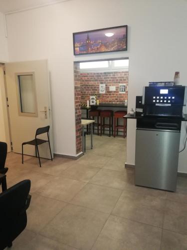 a waiting room with a table and a tv on the wall at The Hostel in Hamburg
