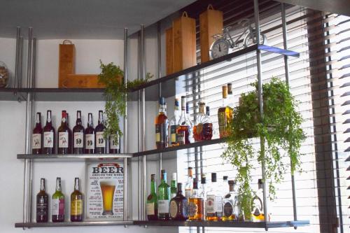 a bar with several bottles of alcohol on shelves at Madeira Regency Cliff - Adults Only in Funchal