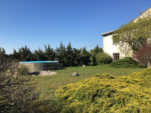 a yard with a swimming pool and a house at Villa de l'Agapé - Drome provencale - 7 ch - 10 à 24 personnes - 350m2 in Tulette