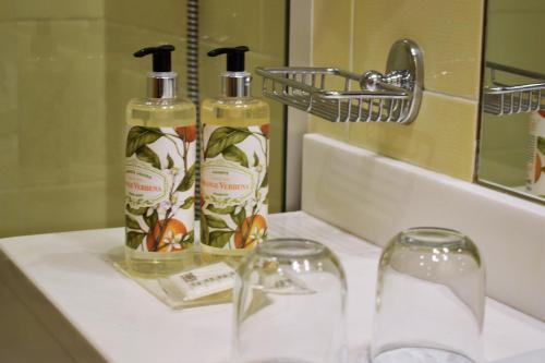 two bottles of soap on a sink in a bathroom at Madeira Regency Cliff - Adults Only in Funchal