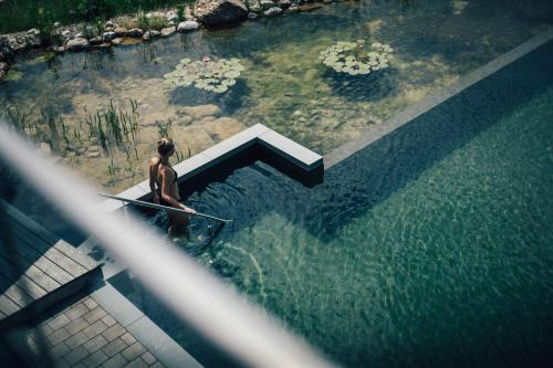 a woman standing in a pool of water at Torghele's Wald & Fluh in Balderschwang