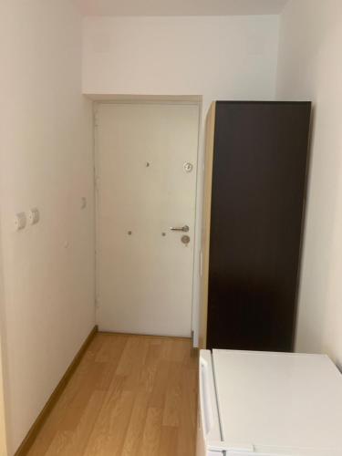 an empty room with a door and a bed in it at Casa Roa in Slănic