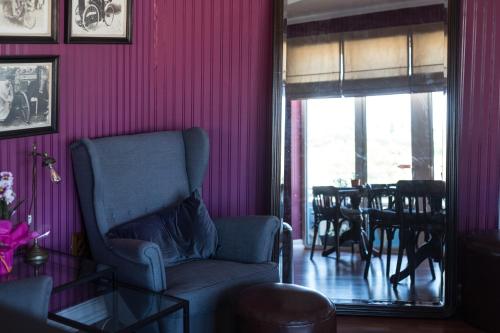 a living room with a chair and a table at Hotel Leiria Classic in Leiria