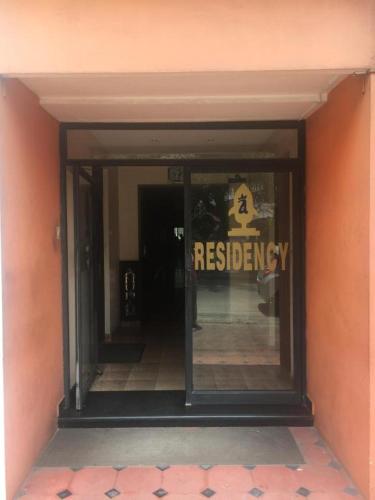 a entrance to a building with a sign on the door at Anupam Residency in Cochin