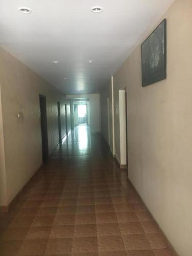 an empty hallway in a building with a tile floor at Anupam Residency in Cochin