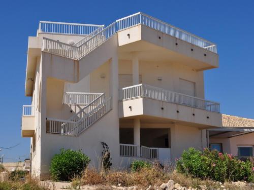 a building with balconies on the side of it at Sagittarius Mare in Marina di Ragusa